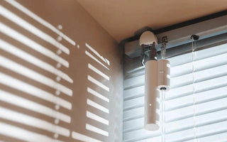 Smart motorized window blind with sleek white design, automated home comfort