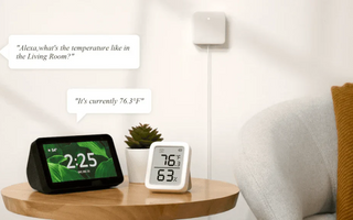 Smart home setup with Alexa-enabled device and digital thermostat displaying 76.3°F in living room