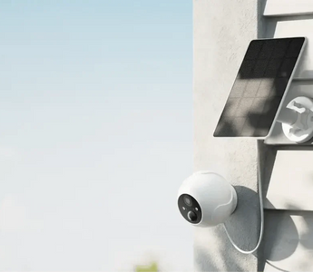 Solar-powered smart security camera mounted on a wall for outdoor home monitoring