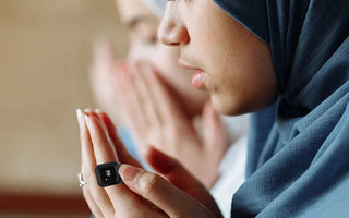 Compact portable digital tasbeeh counter for prayer, held during worship