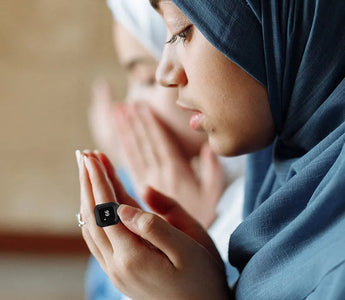 Compact portable digital tasbeeh counter for prayer, held during worship