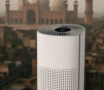 Smart air purifier with digital display on rooftop, city and mosque in background