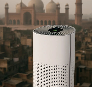 Smart air purifier with digital display on rooftop, city and mosque in background