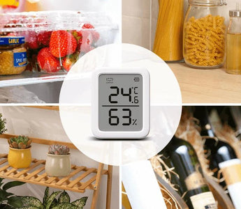 Digital smart thermometer and hygrometer displaying temperature and humidity in home settings