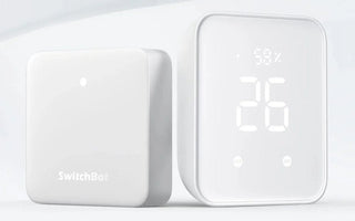 Two white smart home devices on a white background, one with LED display showing humidity and temperature.